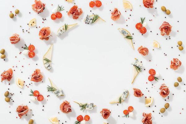 top view of sliced pears with blue cheese near prosciutto, organic ingredients and spices on white background