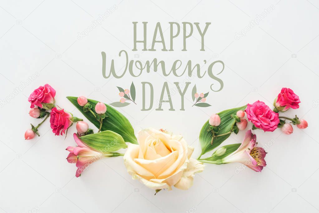 top view of roses and alstroemeria flowers composition on white background with happy womens day lettering
