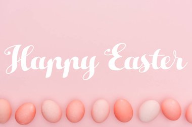 Mutlu Paskalya yazı ile pink izole satırda geleneksel boyalı yumurta