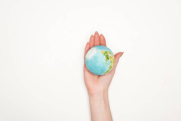 partial view of female hand with earth model on white background, global warming concept