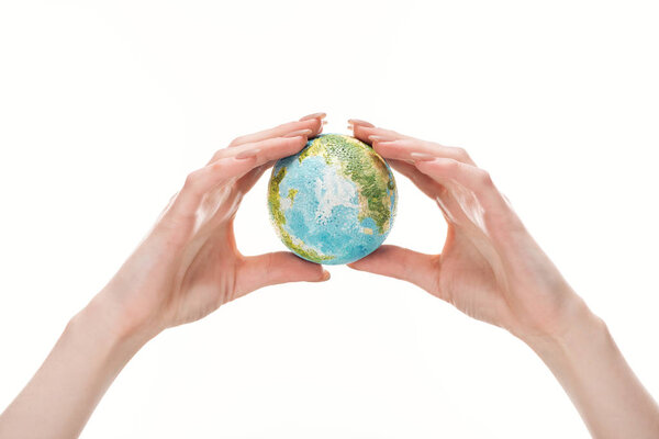 cropped view of female hands with earth model isolated on white, global warming concept