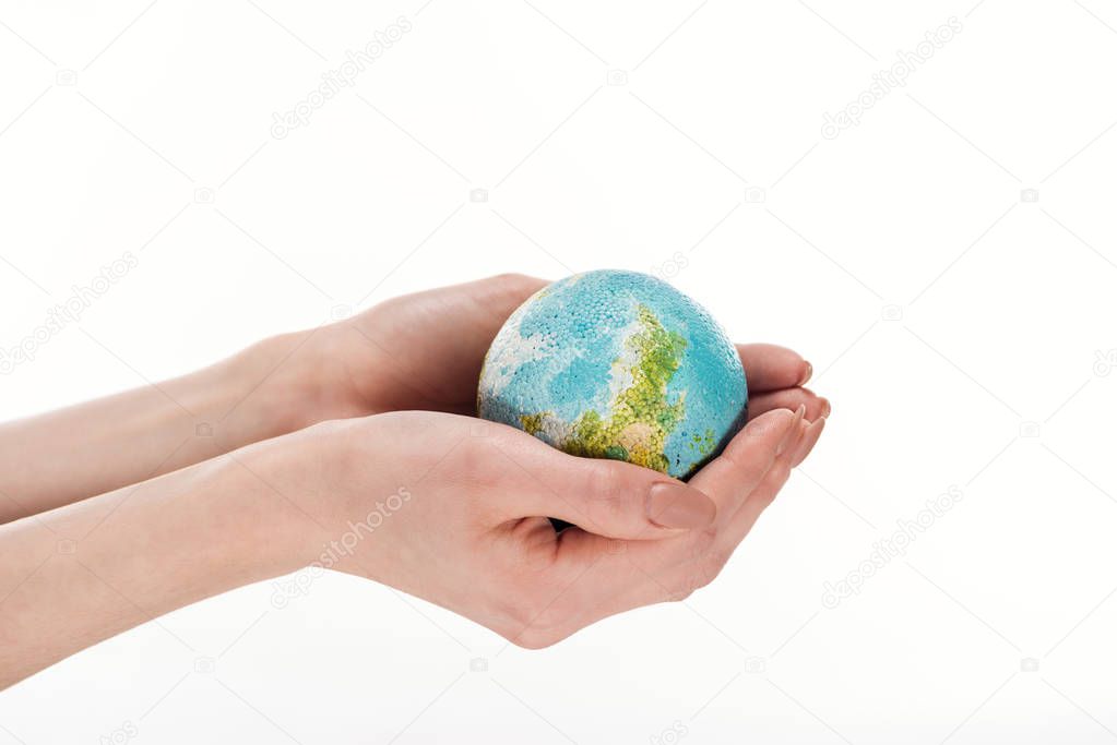 partial view of female hands with globe model isolated on white, global warming concept