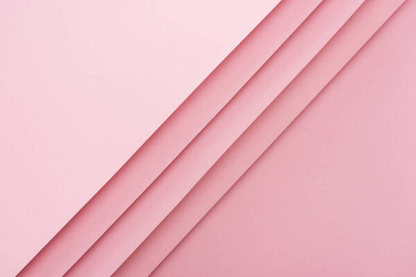 top view of blank and empty sheets of paper on pink background with copy space 
