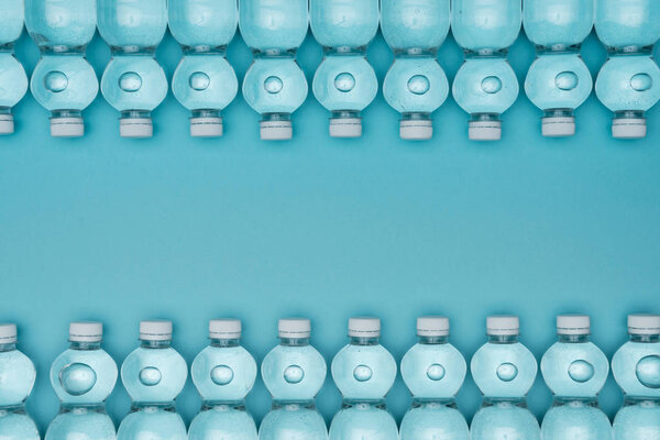top view of frame made of plastic water bottles isolated on turquoise with copy space