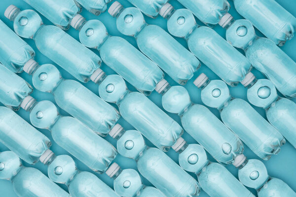 pattern with plastic water bottles isolated on turquoise