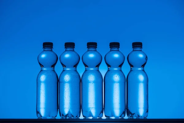 Toned Image Plastic Water Bottles Neon Blue Background Backlit — Stock Photo, Image