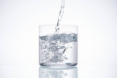 water pouring in drinking glass on white background with backlit clipart