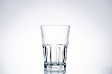 empty glass on white background with backlit and copy space