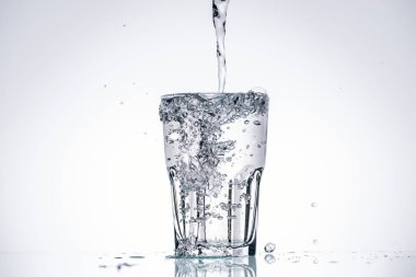 water pouring in full glass on white background with backlit and splashes clipart
