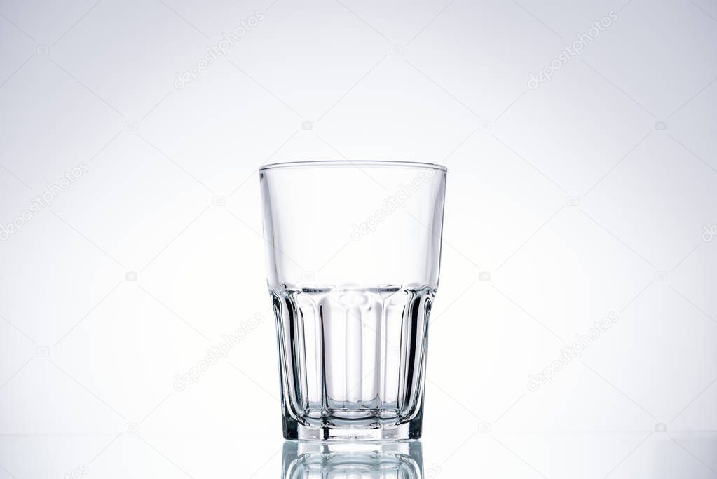 empty glass on white background with backlit and copy space