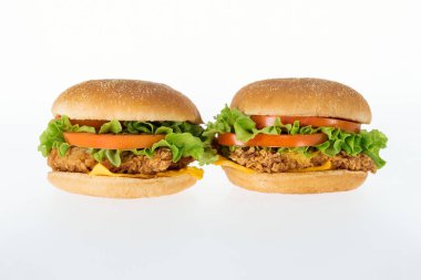 delicious unhealthy chicken burgers isolated on white