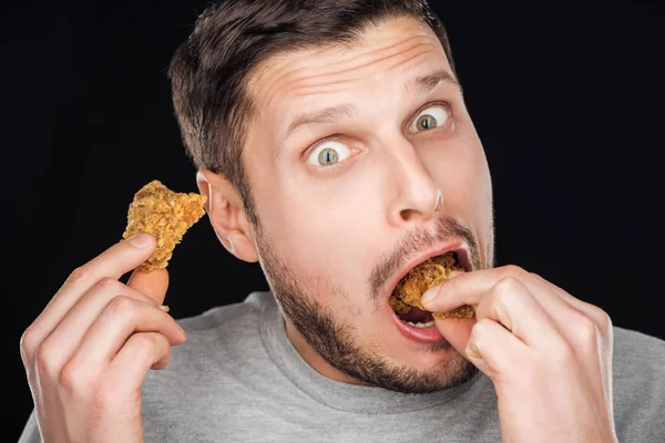 Hombre Emocional Comiendo Sabrosas Pepitas Pollo Mientras Mira Cámara Aislada —  Fotos de Stock