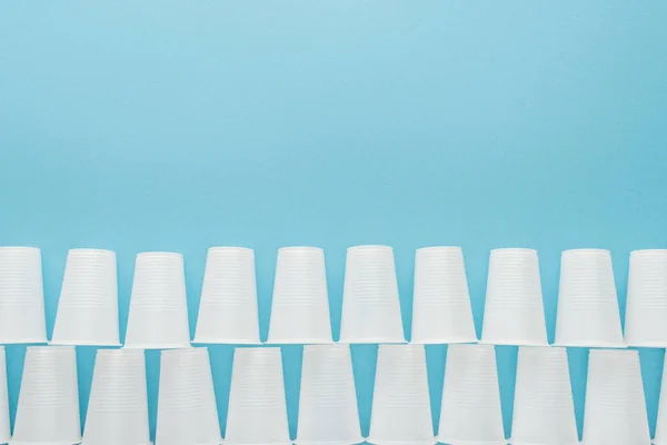 Flat Lay White Plastic Cups Isolated Blue Copy Space — Stock Photo, Image