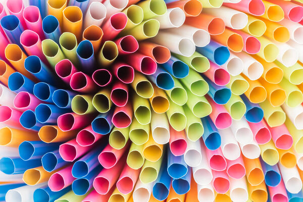 close up of colorful and bright plastic straws with copy space 