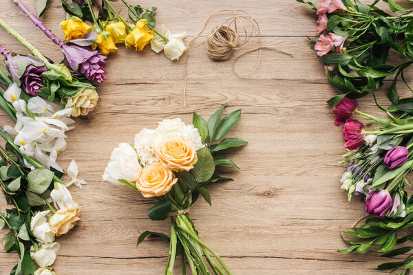 Top view of colorful flower bouquet on wooden surface