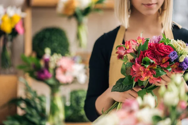 Cropped view of florist in apron holding bouquet in flower shop — Stock Image Cropped View Florist Apron Holding Bouquet Flower Shop Stock Photo