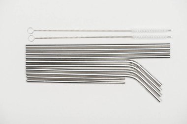 flat lay with stainless steel straws and cleaning brushes isolated on grey clipart