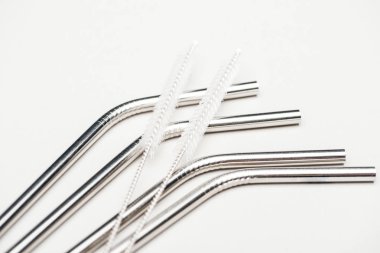 stainless steel straws and cleaning brushes isolated on grey clipart