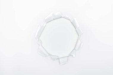 ragged hole in textured paper on white background  clipart