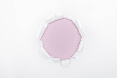 ripped hole in white textured paper on pink background  clipart