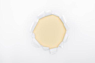 torn hole in white textured paper on ivory background  clipart
