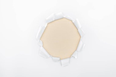 ripped hole in white textured paper on beige striped background  clipart
