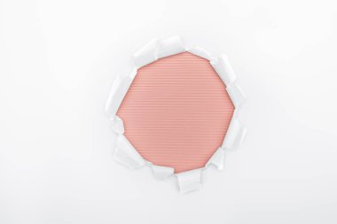 ripped hole in white textured paper on red striped background  clipart