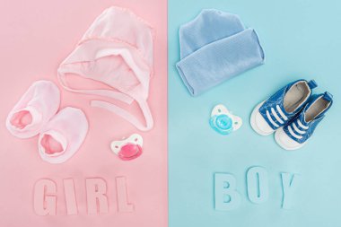 top view of pacifiers, hat, bonnet, booties,sneakers and boy, girl lettering  clipart