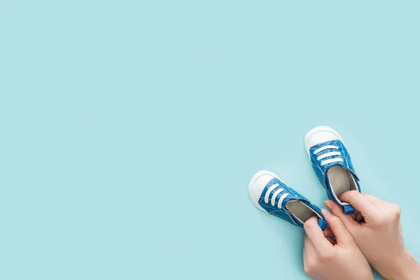 Partial View Adult Woman Holding Sneakers Blue Background Copy Space — Stock Photo, Image