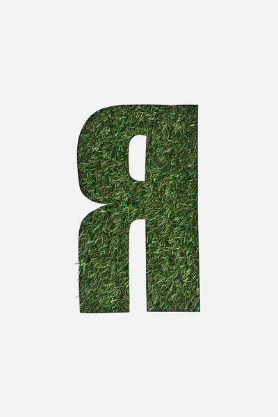 cut out cyrillic letter with green grass on background isolated on white