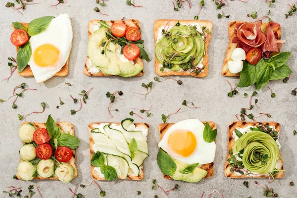 Top View Toasts Vegetables Fried Eggs Prosciutto Textured Surface — Stock Photo, Image