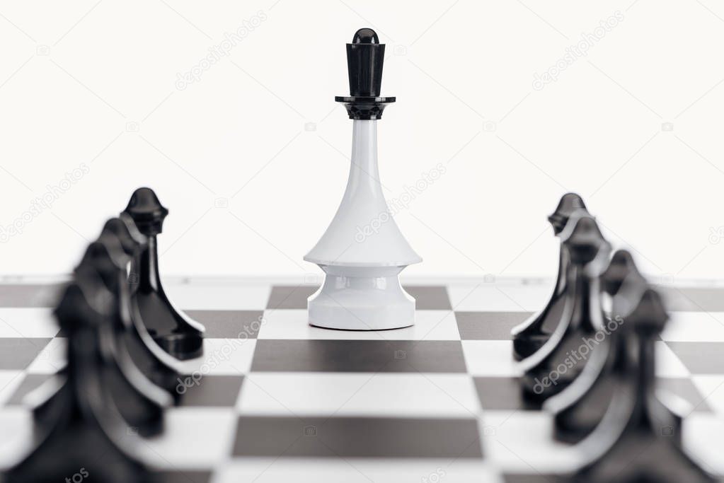 selective focus of chessboard with white queen figure and black pawns isolated on white