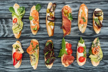 jambon, somon ve sebzeler ile İtalyan bruschetta üstten görünüm ahşap yüzey üzerinde