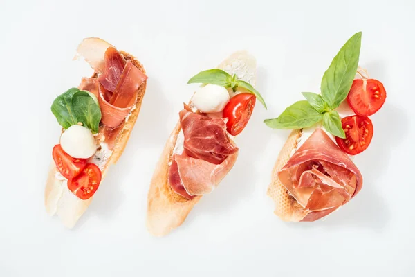 Top View Delicious Italian Bruschetta Prosciutto Mozzarella Basil Tomatoes White — Stock Photo, Image