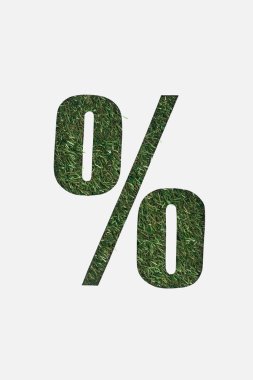 top view of cut out percent sign on green grass background isolated on white clipart