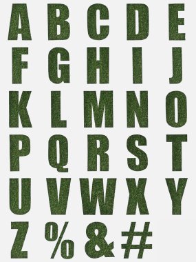 letters from English alphabet made of green grass isolated on white clipart