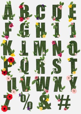 letters from English alphabet made of green grass with fresh leaves and blooming flowers isolated on white clipart