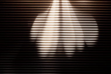 White rays on black textured surface in darkness clipart