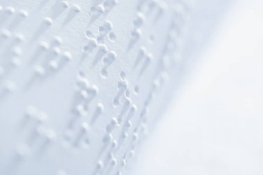 selective focus of braille text on white paper with copy space clipart