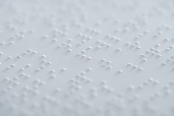 close up view of text in braille code on white paper