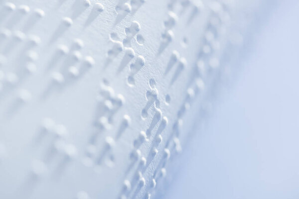 selective focus of braille text on white paper with copy space