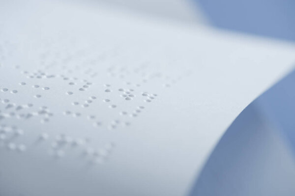 selective focus of braille text on white paper with copy space