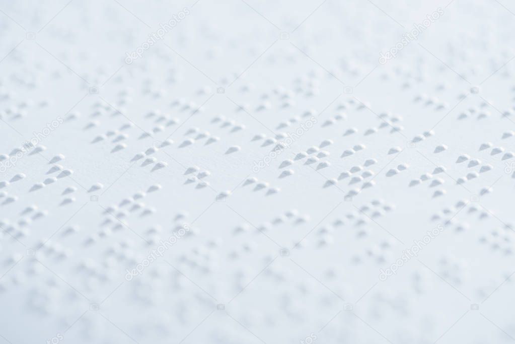 close up view of text in international braille code on white paper