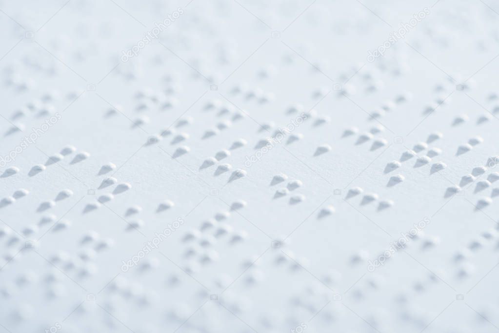 close up view of text in international braille code on white paper