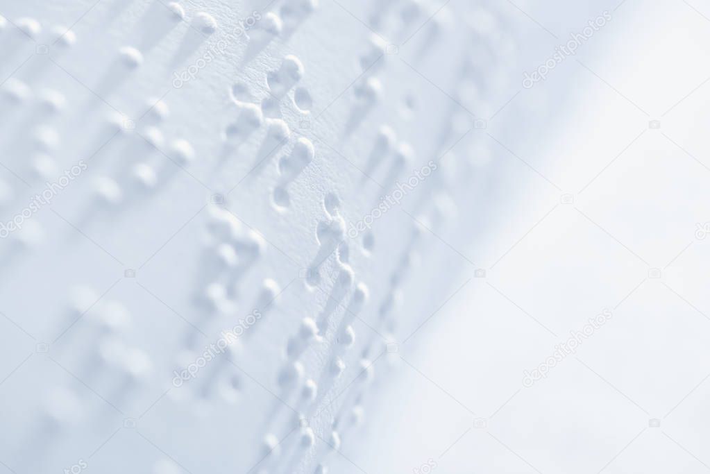 selective focus of braille text on white paper with copy space