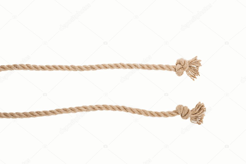lines of brown jute ropes with knots isolated on white 