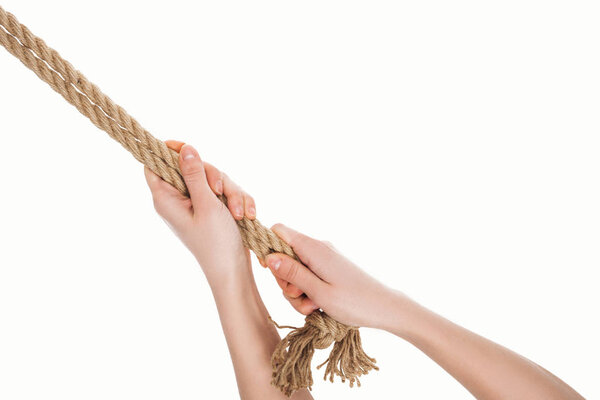 cropped view of woman holding jute brown ropes in hands isolated on white 