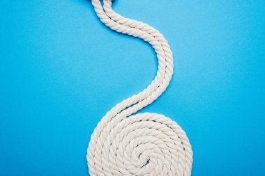 long white waved and twisted ropes isolated on blue clipart