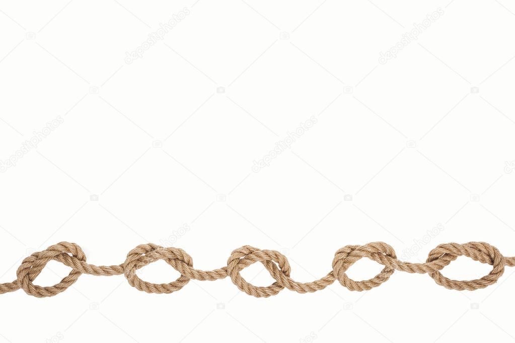 nautical brown rope with sea knots isolated on white 