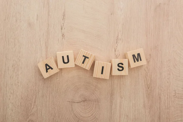 top view of autism lettering made of wooden blocks